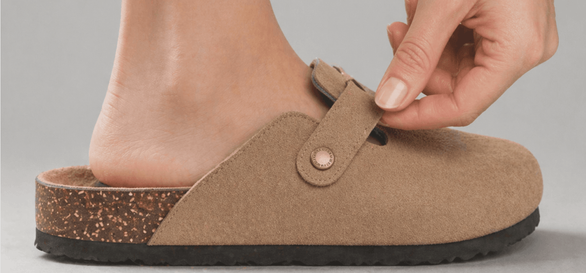 Adjustable buckle strap on a suede clog